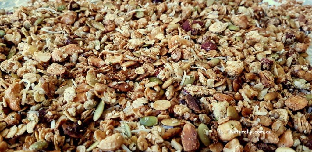 Spread the nut and seed granola on a large try to bake